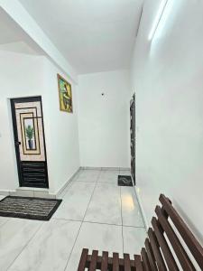 a empty room with a bench and a door at RITHIKA HOMEs in Thekkady