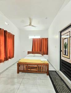 a bedroom with a bed and a window at RITHIKA HOMEs in Thekkady