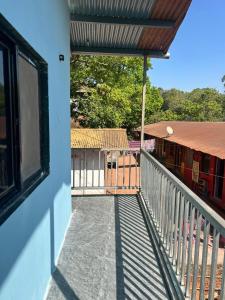 a balcony with a view of a train station at Serenity House in Matheran