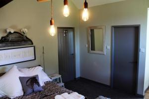 a bedroom with a bed and a mirror and lights at The Jockey Room Hideaway in Spurstow