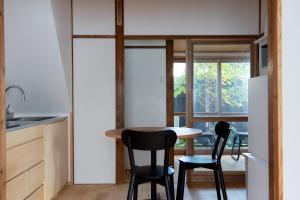 a small kitchen with a table and two chairs at Rotan寺町 in Matsue