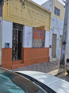 a store with a sign on the front of a building at Pousada Rio do Mar in Aracaju