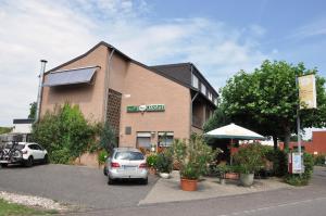a car parked in a parking lot in front of a building at Effelder Bürgerstube in Effeld +6 photos