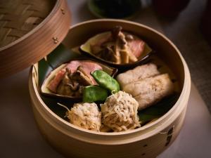 a wooden bowl filled with different types of food at Glamday style hotel suite 山ノ麓 in Karuizawa