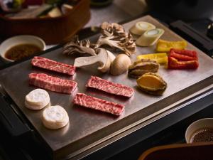 a tray filled with different types of meats and vegetables at Glamday style hotel suite 山ノ麓 in Karuizawa