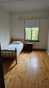 an empty bedroom with a bed and a window at Griffin lakeside in Yarralumla