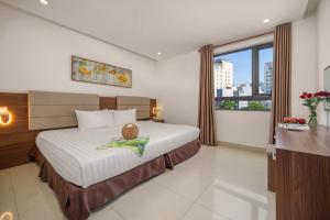 Postel nebo postele na pokoji v ubytování Lumina Hotel & Apartment