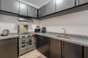 a kitchen with stainless steel cabinets and a sink at Riad Cherifa Breakfast and Jacuzzi Terrace in Marrakesh