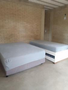 Postel nebo postele na pokoji v ubytování Kitnet in São Gonçalo do Rio das Pedras, Serro-MG + 7 fotografií