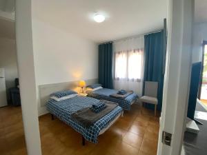 two beds in a small room with a window at Apartment with private balcony in San Javier +12 photos