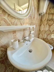 a bathroom with a white sink and a mirror at Sperlonga Center Home in Sperlonga +77 photos