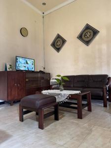 a living room with a couch and a coffee table at Rumah Cahaya Syariah Peaceful Family Home in Rampal