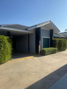 een huis met een oprit ervoor bij M-Resort Pathum-thani Thailand in Ban Khlong Sam Wa (3)