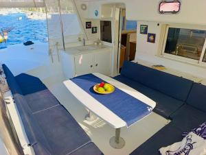 a table in a boat with a bowl of fruit on it at catamaran yatch tour in Göcek