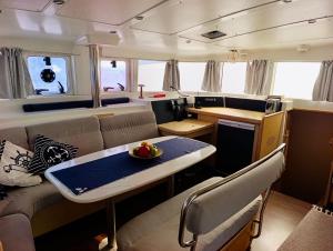 a kitchen and living room with a table in a van at catamaran yatch tour in Göcek