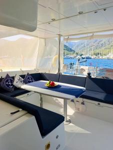 a table on a boat with a bowl of fruit on it at catamaran yatch tour in Göcek