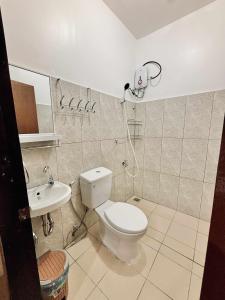 a bathroom with a shower and a toilet and a sink at LUZVILLE Transient House - Port Barton in Itaytay +73 photos