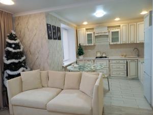 un soggiorno con divano e albero di Natale di Апартаменты в районе Космос ad Aqtöbe