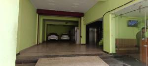 an empty hallway with two cars parked in a garage at Star hill in Rishīkesh