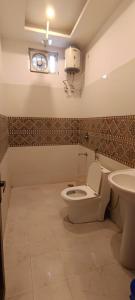 a bathroom with a toilet and a sink at Star hill in Rishīkesh