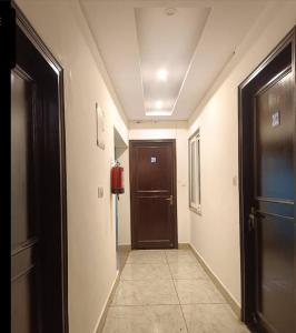 a hallway with a brown door and a hallway sidx sidx sidx at Star hill in Rishīkesh