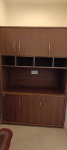 a closet with wooden shelves in a room at Star hill in Rishīkesh