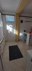 a kitchen with a door and a table and a counter at Vaso & Viktor Apartment in Kotor