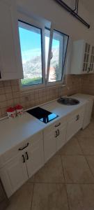 a kitchen with a sink and a window at Vaso & Viktor Apartment in Kotor +86 photos