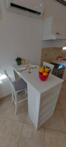 a kitchen with a table with a bowl of oranges on it at Vaso & Viktor Apartment in Kotor