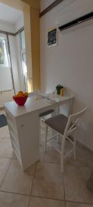 a kitchen with a table and a bowl on a table at Vaso & Viktor Apartment in Kotor