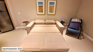 a hospital room with a couch and a chair at Book Santos - Apartamentos no Unique Residence in Santos