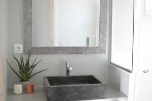 a bathroom with a sink and a mirror at Maison d'Hôtes Les Petites Terres in Sainte-Marie-de-Ré