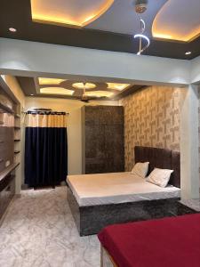 a bedroom with a large bed in a room at Hotel Nav Prayag Inn in Prayagraj