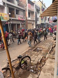 a group of people walking down a city street at Hotel Nav Prayag Inn in Prayagraj +15 photos
