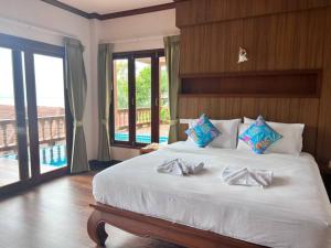 a bedroom with a bed with two bow ties on it at Haad Yao Bayview Resort & Spa - SHA plus Certified in Haad Yao +38 photos