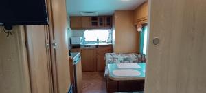 a small kitchen with a small table in a room at 노을이 아름다운 호미곶 캠핑카 in Sup'sil