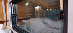 a reflection of a couch in a window at 노을이 아름다운 호미곶 캠핑카 in Sup'sil