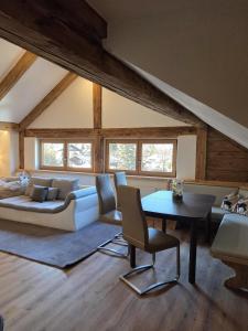 a living room with a couch and a table at Resi´s Stadthaus in Kitzbühel