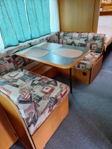 a room with two bunk beds and a table at 노을이 아름다운 호미곶 캠핑카 in Sup'sil +31 photos