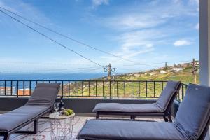 a balcony with two chairs and a view of the ocean at Estrela House I Calheta Madeira in Calheta