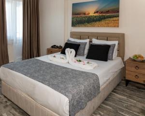 a bedroom with a large bed with two pillows at Zileli Suıtes in Hamidiye