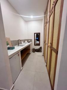 a hallway of a bathroom with a sink and a mirror at Haad Yao Bayview Resort & Spa - SHA plus Certified in Haad Yao