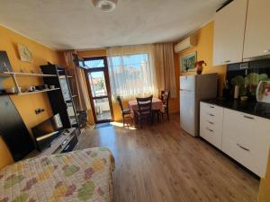 a kitchen with a couch and a table in a room at Dom Lidiya in Pomorie