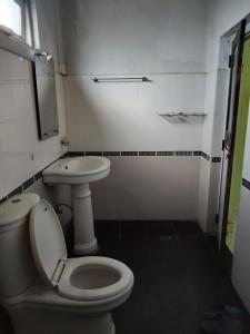a bathroom with a toilet and a sink at Foreign Home Stay in Katugastota +8 photos