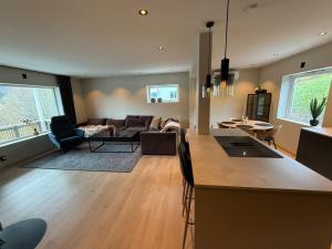 a kitchen and living room with a couch and a table at Nyoppusset leilighet til leie in Isfjorden