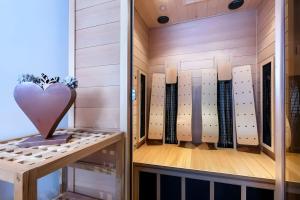 a locker room with a heart on the wall at Mountain Lodge Leogang-Premium Apartment, Balkon, Bergblick, Kamin, Sauna in Leogang +1 photo