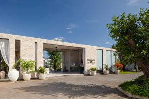 a large brick building with plants in front of it at Hidden City Ubud - Modern Comfort & Relaxed Living near Central Ubud and Green Fields in Ubud