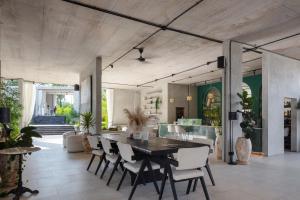a large dining room with a table and chairs at Hidden City Ubud - Modern Comfort & Relaxed Living near Central Ubud and Green Fields in Ubud +26 photos