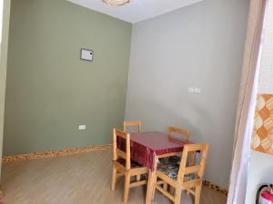 a dining room with a table and two chairs at Jangwani Riverview Suits in Mto wa Mbu