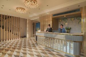 two people sitting at a bar in a hotel lobby at BluSalzz Residence Amritsar in Amritsar +92 photos